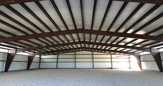 Clear-span riding arena with kickwall, viewing area and column-free footing.