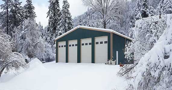 Shop building with overhead doors, walk door and matching trim.
